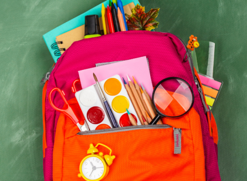 Backpack filled with school supplies representing the Worth Township Apple Tree School Supply Program.