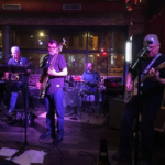 Photo of The Timeline Band performing live on stage to promote the Summer Concert at Mayor's Park on August 20.